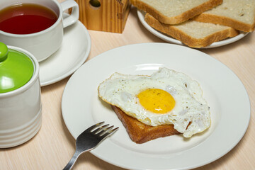 Fried eggs on toast. Delicious and nutritious breakfast on the table. Snack with tea