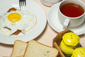 Fried eggs on toast. Delicious and nutritious breakfast on the table. Snack with tea