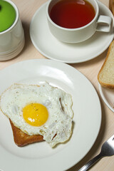 Fried eggs on toast. Delicious and nutritious breakfast on the table. Snack with tea