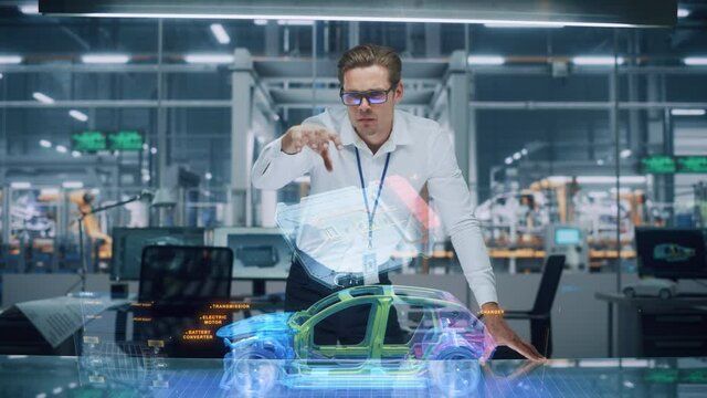 Green Energy Car Design: Automotive Engineer Using Augmented Reality Hologram to Construct 3D Model of High-Tech Electric Vehicle Optimizing Battery Efficiency. Automated Robot Arm Manufacturing