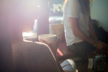 woman holding cup of tea