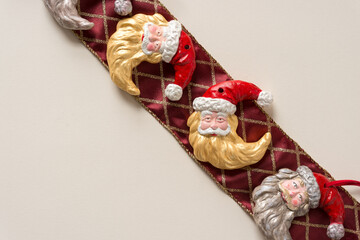 grungy santa face christmas ornaments arranged on fancy ribbon