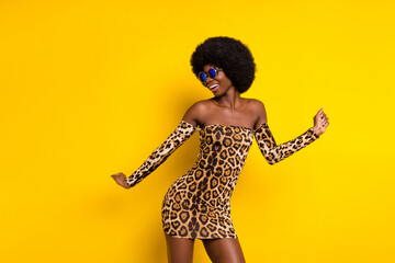 Photo of shiny pretty dark skin lady wear off-shoulders clothes eyewear dancing smiling isolated yellow color background