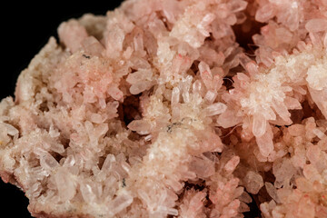 Macro stone mineral pink quartz amethyst on a black background