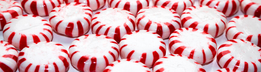 banner size christmas peppermint hard candy cane mints close up background