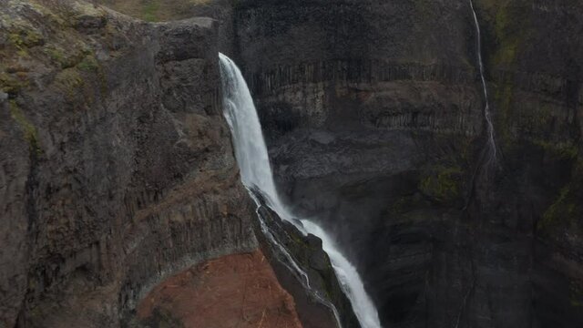 Aerial view of Haifoss and Granni waterfall in Iceland. Drone view of two jets of water crashing against the rocks and transformed into water dust. Waterfall on the Fossa river