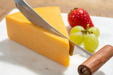 Cheese collection, piece of British yellow cheddar cheese made in Somerset from cow milk