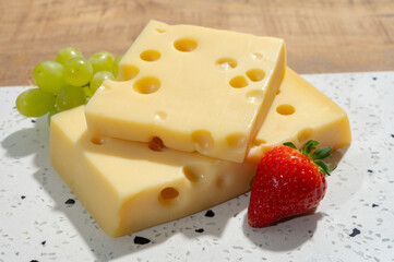 Cheese collection, blocks of French emmentaler cheese with many round holes made from cow milk