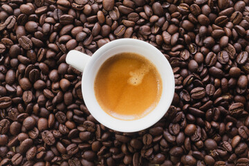 Macro view flat lays of coffee beans and a cup of coffee background