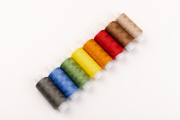 Color sewing threads isolated on white background. Different colors.Bright bobbin thread.