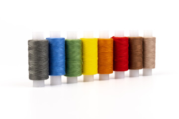 Color sewing threads isolated on white background. Different colors.Bright bobbin thread.