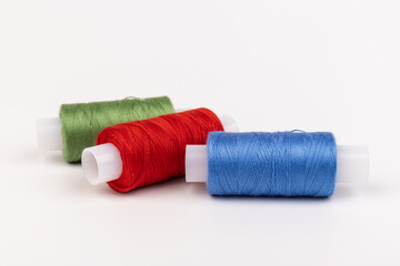 Color sewing threads isolated on white background. Different colors.Bright bobbin thread.