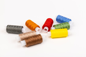 Fototapeta na wymiar Color sewing threads isolated on white background. Different colors.Bright bobbin thread.
