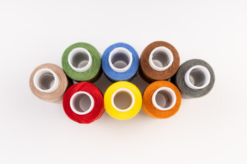 Color sewing threads isolated on white background. Different colors.Bright bobbin thread.