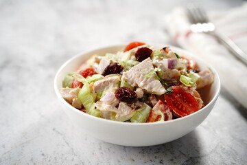 Homemade Chicken salad in a white bowl, selective focus
