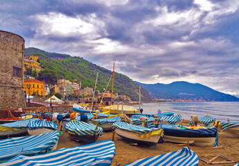 Fishing boats in cloudy weather on the beach of Laigueglia, Savona, Liguria, Ligurian Sea, Italy.