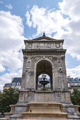Fototapeta na wymiar Fountain of the Innocents (Fontaine des Innocents, 1547 - 1550) at place Joachim-du-Bellay in Paris. Fountain of the Innocents is oldest monumental fountain in Paris, France.