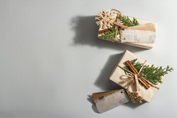 Fototapeta na wymiar Zero waste gift concept. Christmas or New Year eco-friendly packaging. Festive boxes in craft paper