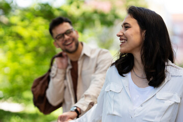 Happy young couple outdoors. Loving couple walking in the city