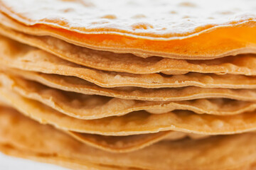 Layers of baked crumpets cakes made of puff pastry for cake. Semi-finished product for cake.