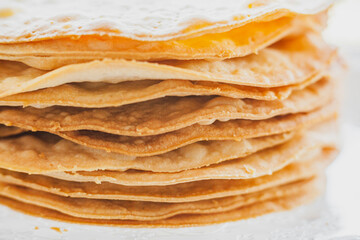 Baked crumpets cakes made of puff pastry for layer cake on a glass stand. Semi-finished product for cake.