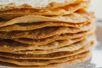 Layers of baked crumpets cakes made of puff pastry for cake. Semi-finished product for cake.