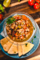 Colorful Food Appetizer Starts Snacks Fresh Delicious Menu Recipe Meal Meat Chicken Fries Fish Seafood Beer on a wooden table on the Beach