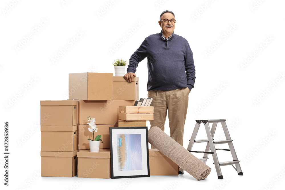 Wall mural Mature man standing next to cardboard boxes packed for removal