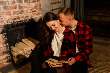 Young guy kissing his lovely girlfriend feeling happiness while celebrating winter holidays together