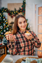 woman holding sweet desserts and enjoying christmas atmosphere