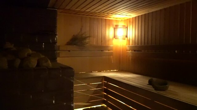Traditional old Russian bathhouse SPA Concept. Interior details Finnish sauna steam room with traditional sauna accessories basin birch broom scoop felt. Relax country village bath concept.