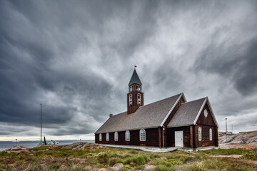 Historic wooden church of Ilulissat, Greenland against grey overcast sky