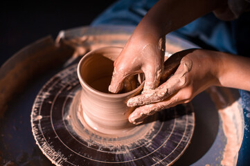Pottery girl sculpts from clay. Handmade products. Close-up.