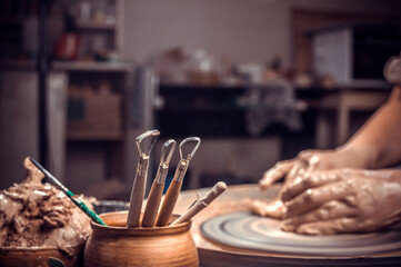 The hands of the master who makes the jug. Close-up.