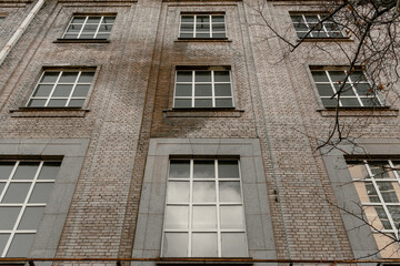 Bottom view of a brown brick building with many windows