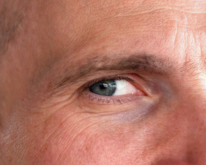Fototapeta premium Close-up of a man's face. Adult man's eye.