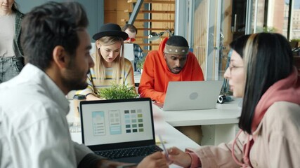 Unhappy app designer is working with laptop then leaving office feeling disappointed with results while colleagues are expressing concern - Powered by Adobe