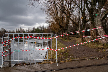 street fence near the water with a stretched red tape