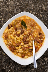 a plate of winter Tuscan bean soup with whole grains. traditional italian cuisine