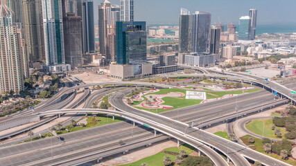 Aerial view on Dubai Marina with big highway intersection timelapse and skyscrapers around, UAE