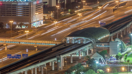Metro station and traffic on a highway between Dubai media city and golf course night timelapse