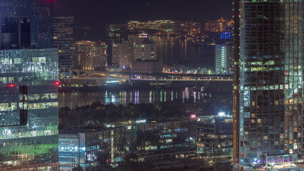 Fototapeta na wymiar Office buildings in Dubai Internet City and Media City district aerial night timelapse