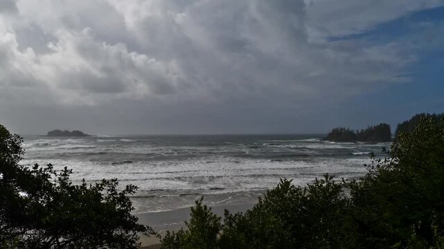 View of the wild coast of the Pacific Ocean at Florencia Bay in Pacific Rim National Park Reserve near Tofino on Vancouver Island, British Columbia, Canada on cloudy day in autumn season with rough se
