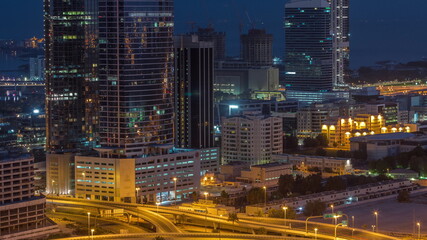 Fototapeta na wymiar Office buildings in Dubai Internet City and Media City district aerial night to day timelapse