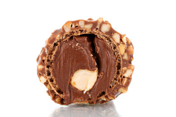 One half of chocolate candy with nuts, close-up, isolated on white.