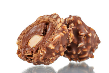 Two halves of chocolate candy with nuts, close-up, isolated on white.