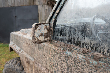 closeup side mirror of dirty jeep