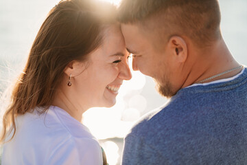profiles couple in love having fun on the sea beach. solar glare