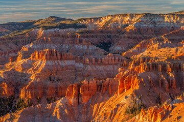 USA, Utah. Cedar Breaks National Monument, evening light warms eroded sandstone formations, view...