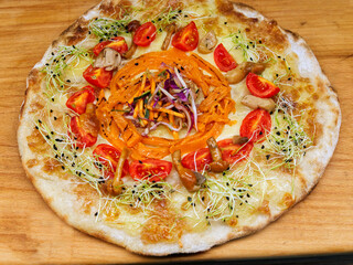 a gourmet pizza with julienne-cut pumpkin and mushrooms